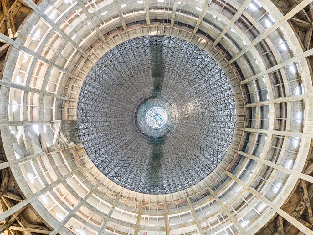 Looking up into the main dome of the Temple of the Vedic Planetarium, its ribs and scaffolding radiating from the oculus